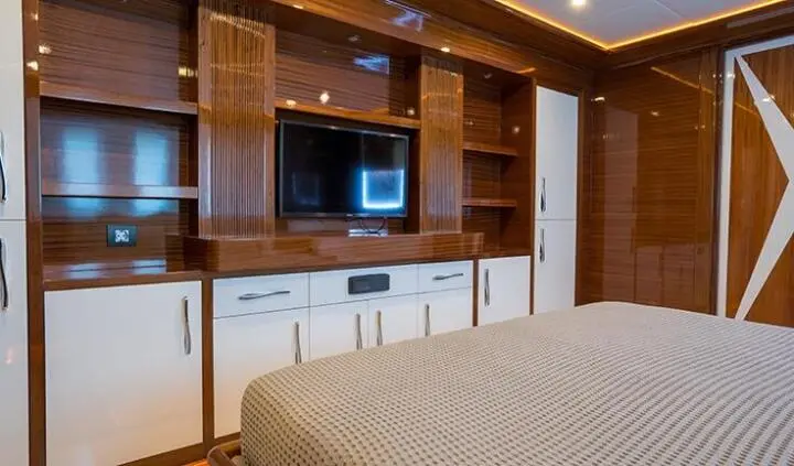 Master cabin aboard yacht with king bed, ensuite and built-in storage