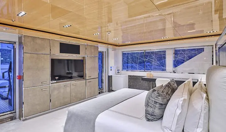 Master cabin with king bed and beige upholstery on La Pellegrina 1 yacht interior