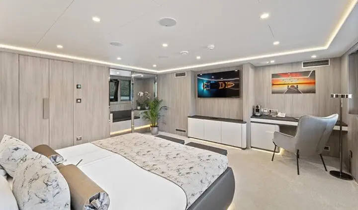 Master cabin with king bed and ensuite on Freedom yacht, bright interior