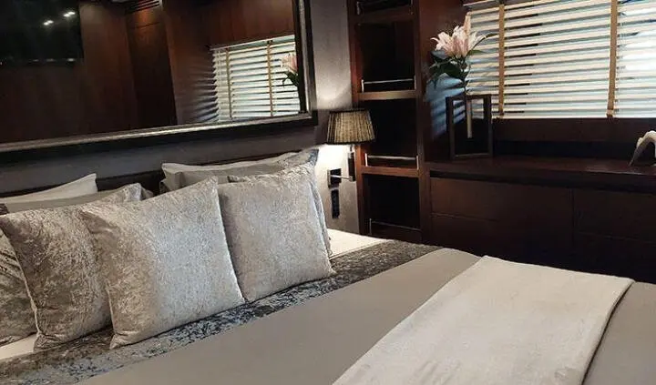 Miraval master cabin with king bed, plush pillows, and ensuite door visible