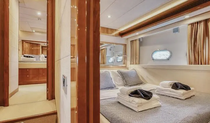 Master cabin with king bed, ensuite, and warm wood finishes aboard Lidia