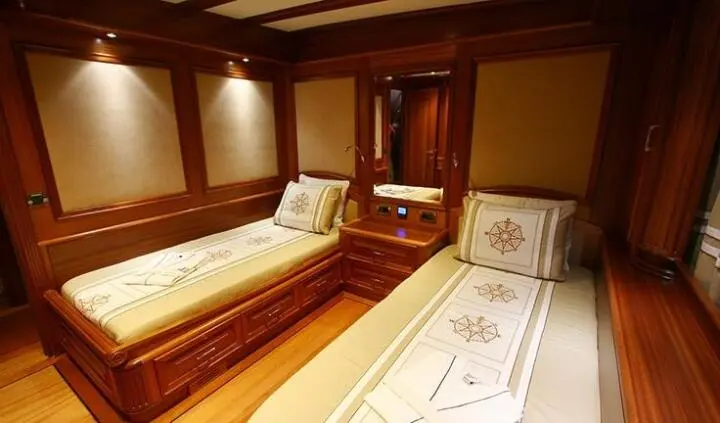 Twin cabin interior on Kaya Guneri 5 yacht with two single beds and wood paneling