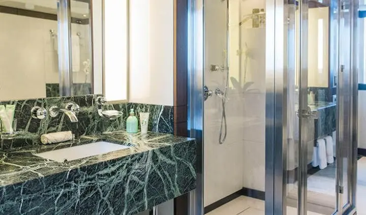 Master cabin with king bed and ensuite features marble countertop vanity