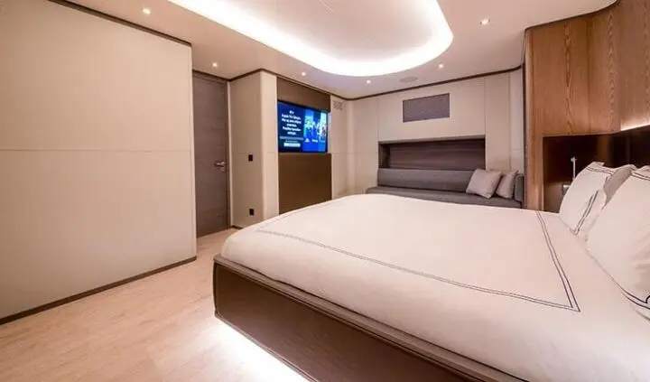 Master cabin with king bed, ensuite, and soft lighting aboard Good Life