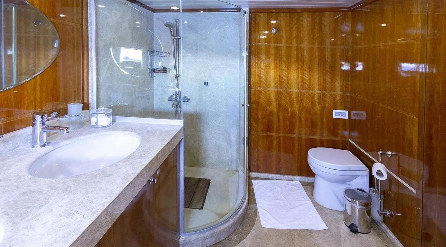 Silver Moon yacht interior: modern bathroom with glass shower and wooden paneling