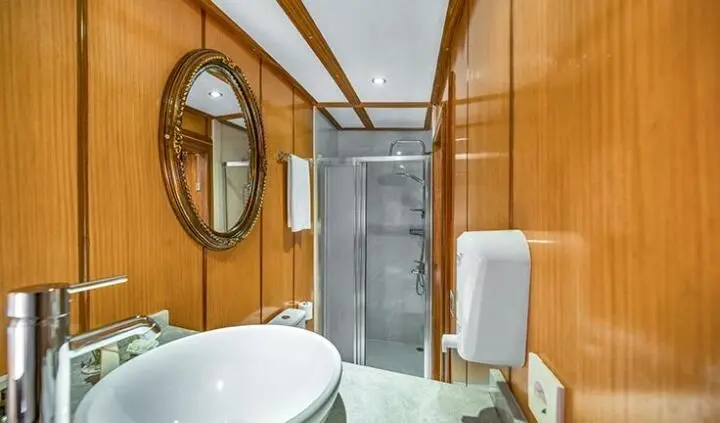 Cabin aboard Tersane 8 yacht with king bed, ensuite bathroom visible