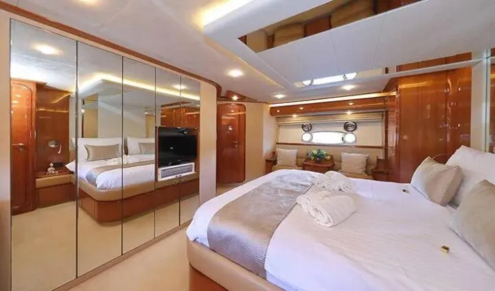 Quo Vadis I master cabin with king bed, ensuite, wood cabinetry, soft lighting