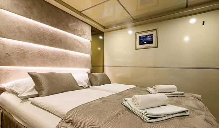 Melody yacht master cabin with king bed, ensuite view and neutral decor
