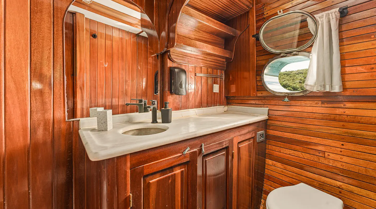 Luxurious yacht interior with polished wooden cabinetry and sink area