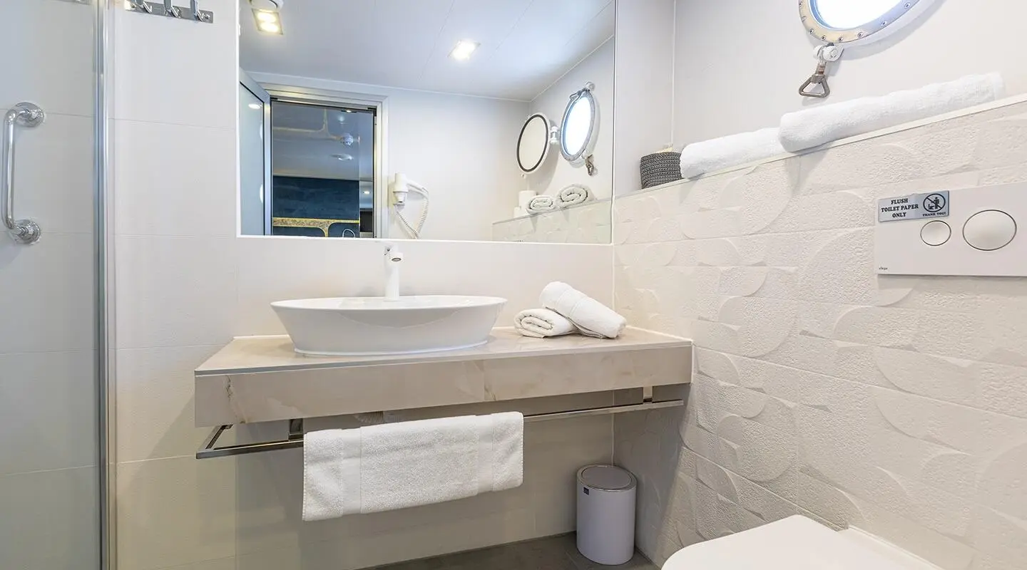 Yolo luxury yacht bathroom with double sink, mirror, and towel rail