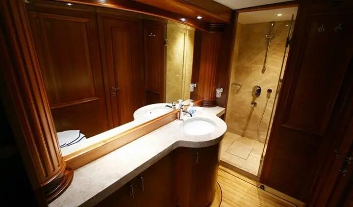 Master cabin with king bed and ensuite vanity, wood cabinetry