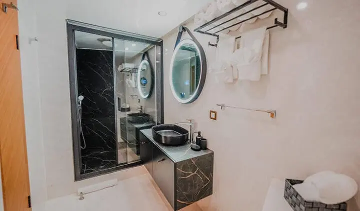 Master cabin aboard King Of The Sea with king bed and ensuite visible