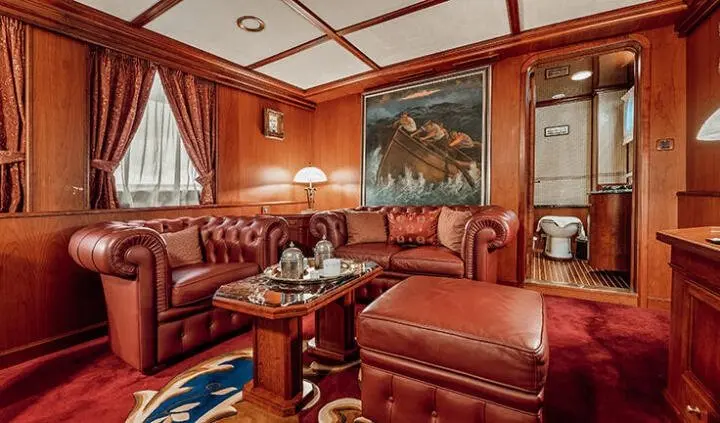 Seagull II master cabin with king bed, leather seating, wooden walls