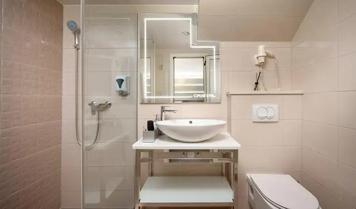 Yacht Cristal cabin bathroom with sink, mirror, and bench in view