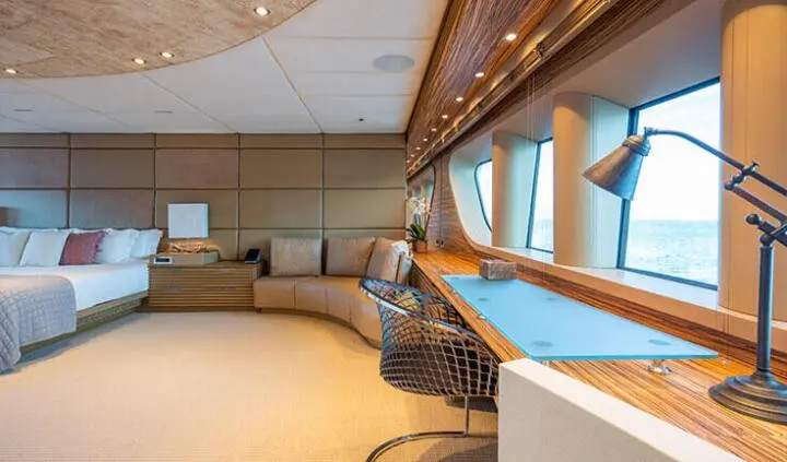Master cabin with king bed, ensuite vanity, and large windows on Serenity