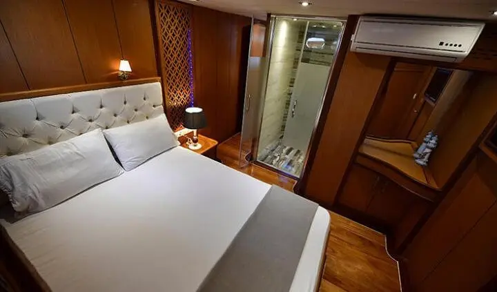 Blu Dream cabin with a king bed, white bedding, wood features, and ensuite door