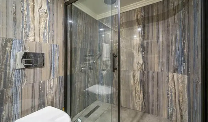 Queen Of Makri cabin ensuite aboard a yacht with glass shower door
