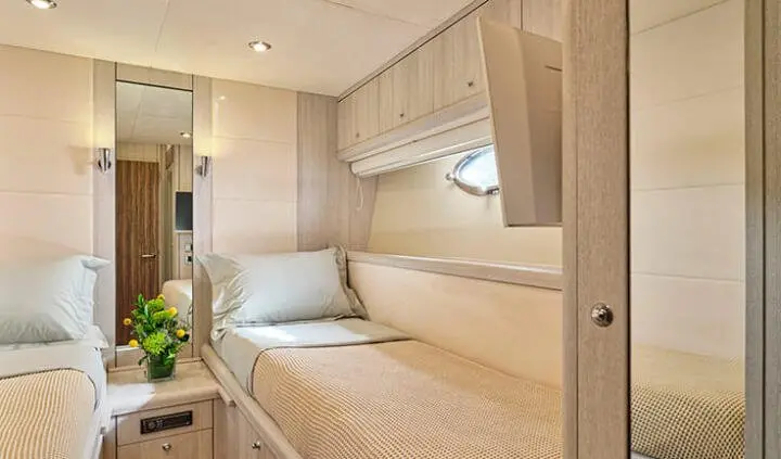 Master cabin with king bed, side desks, and built-in storage on yacht