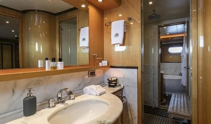 Master cabin with king bed and en suite bathroom on yacht interior
