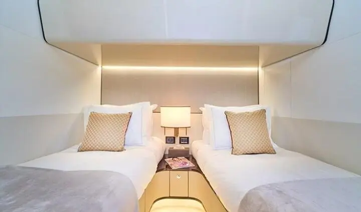 Twin-berth luxury cabin on Aluminia Too yacht with two beds and nightstands