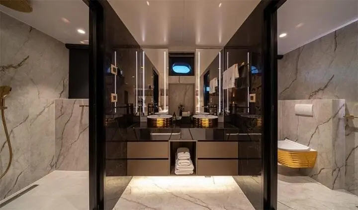 Nocturno yacht master cabin with king bed and ensuite bathroom visible