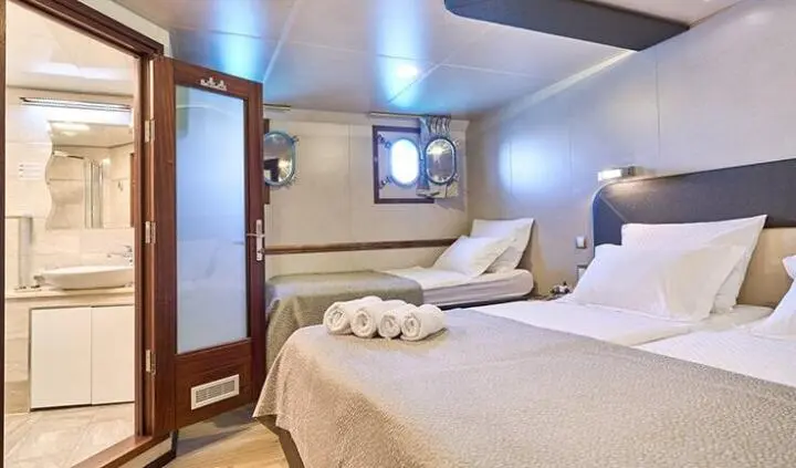 Casablanca yacht cabin with king bed, ensuite, soft lighting and seating