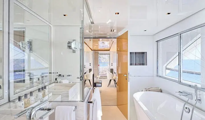 Interior view of a yacht cabin with a large bed and ensuite bathroom