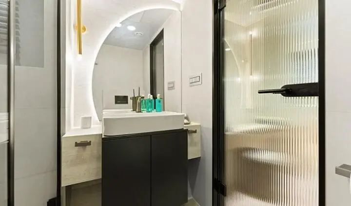 Master cabin with king bed, ensuite, marble accents, and glass shower