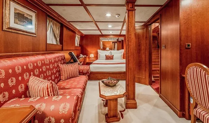 Seagull II cabin with a king bed, ensuite view, warm wood tones, seating area