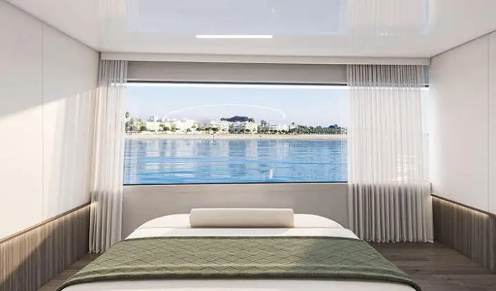 View from a yacht cabin bed overlooking water and distant shoreline