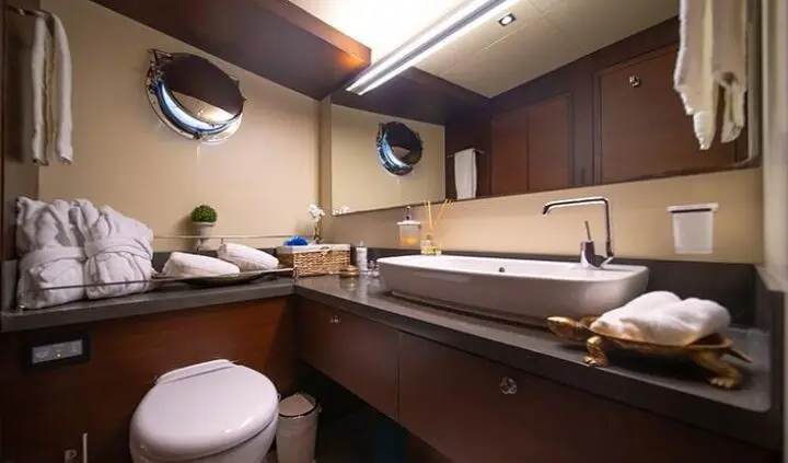 Downstairs cabin aboard Double Eagle yacht with bed, seating, and cabinetry