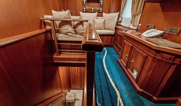 Seagull II cabin interior with double bed and wooden cabinetry.