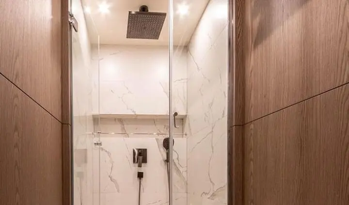 Master cabin with king bed, ensuite marble bathroom, wooden accents