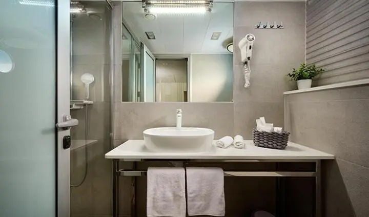 Ohana cabin ensuite bathroom on yacht, single sink vanity and mirror