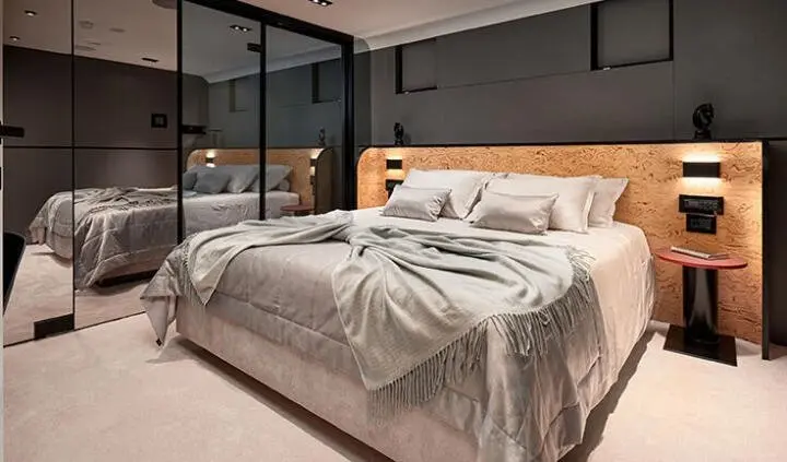 Anetta cabin with a king bed, neutral linens, wood headboard, window view