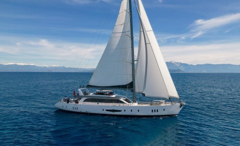 Long Island luxury sailing yacht with white hull and tall sails gliding on blue sea