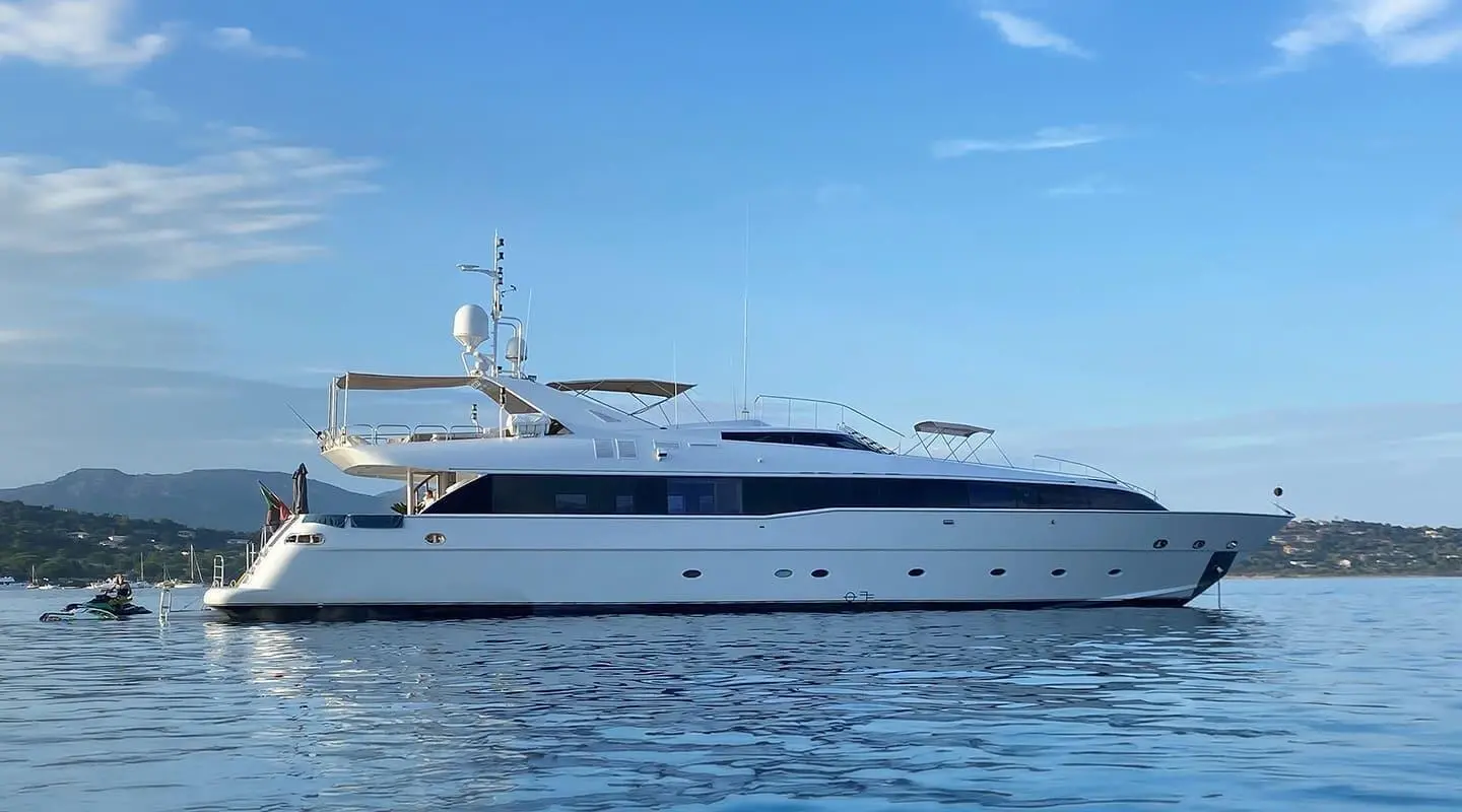 Yacht Brooklyn anchored on calm blue water with clear sky