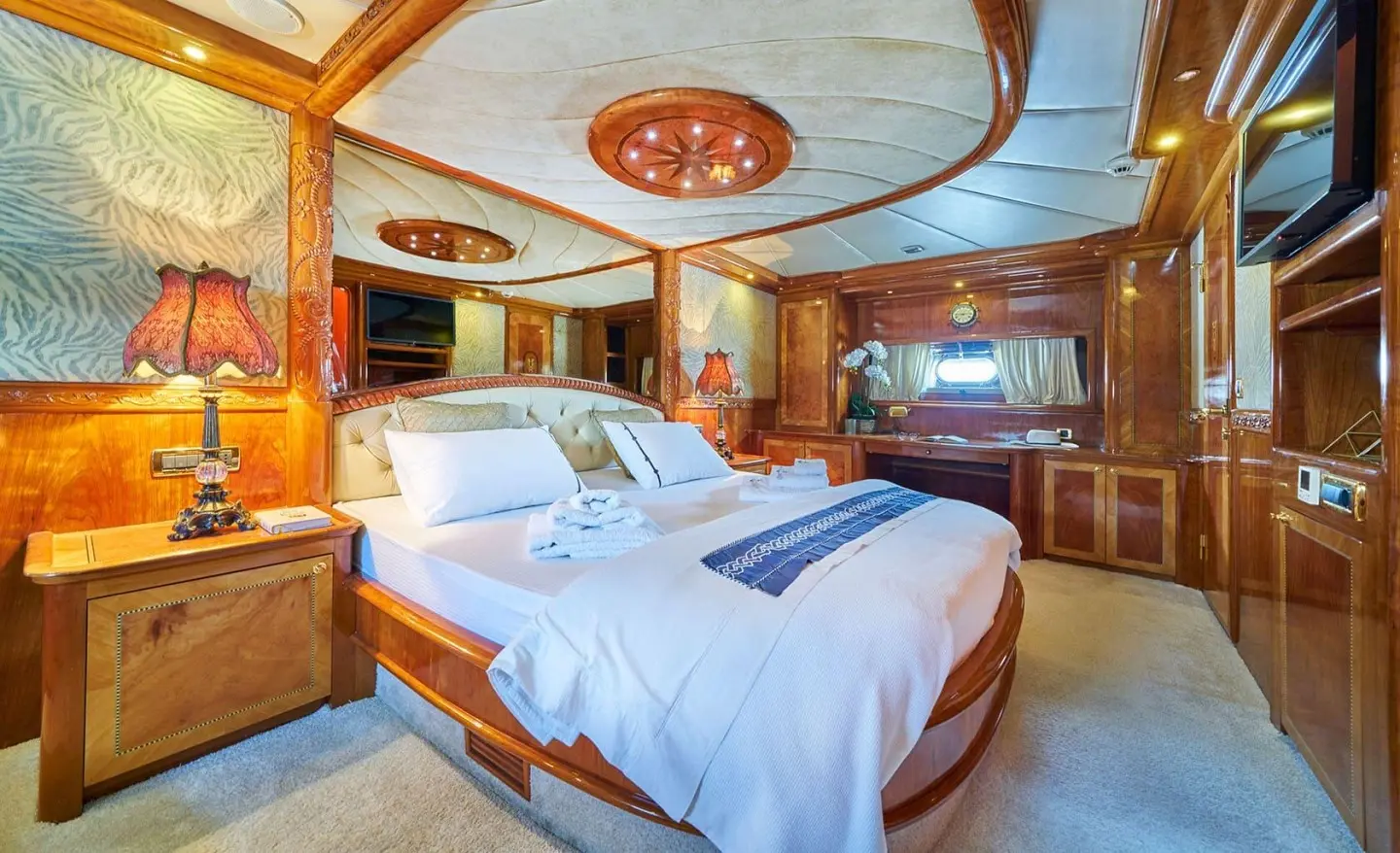 Gulet Lotus master cabin with two beds, wooden interior and blue bedding