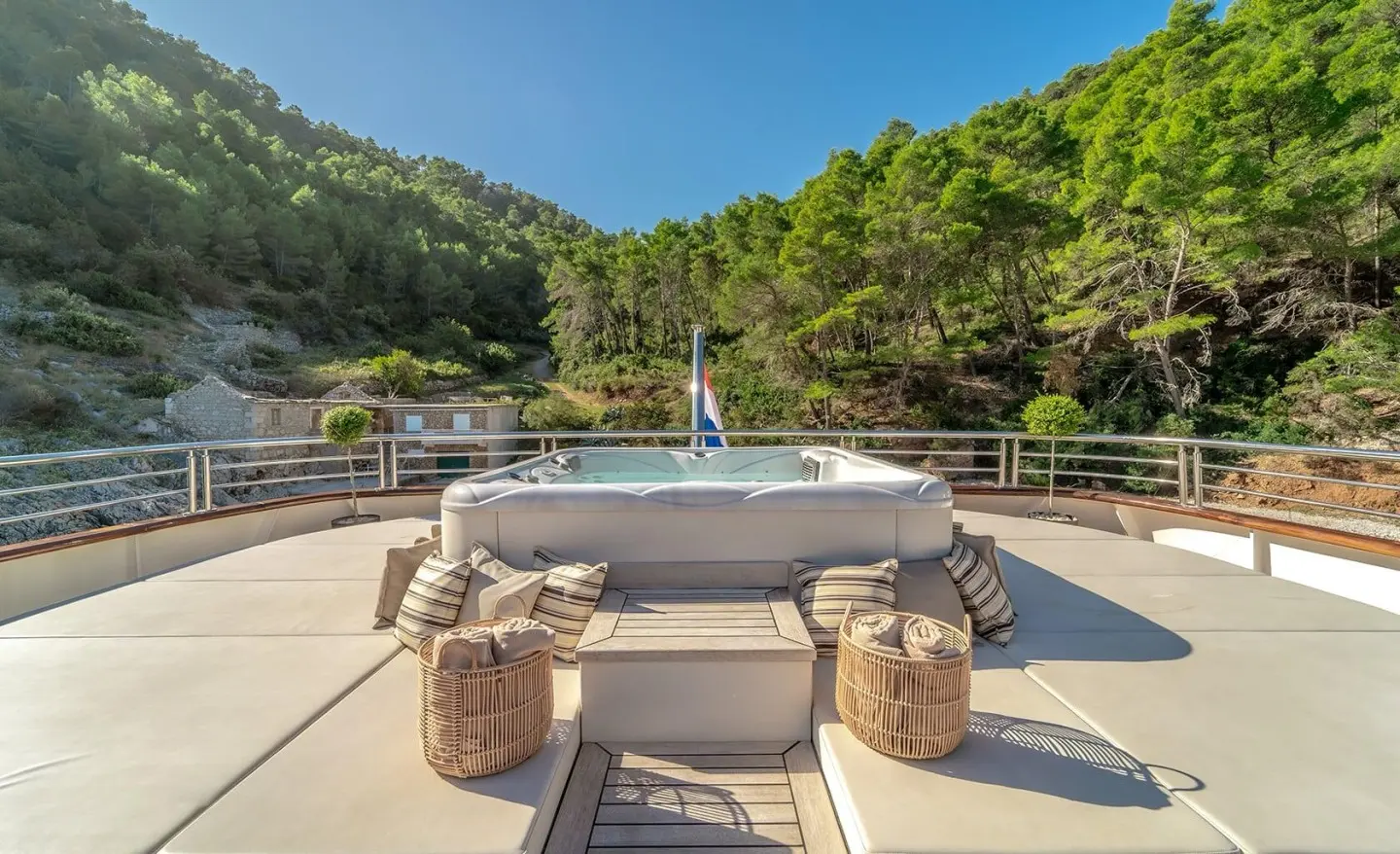 Yacht Freedom lounge area with wicker seating and a jacuzzi on deck