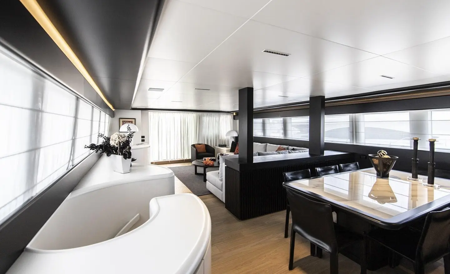Spacious interior with white furniture, seating area, and dining table