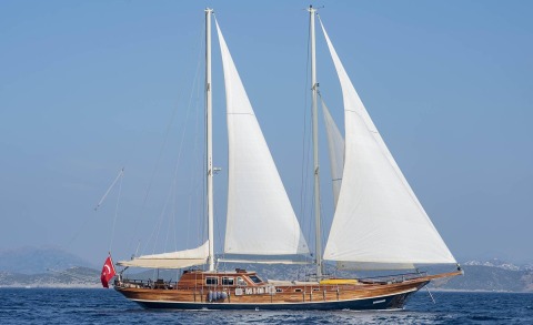 Samarkand luxury sailing yacht with tall masts and white sails on blue sea