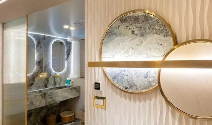 Cabin interior on Scorpios yacht with circular mirror and warm lighting