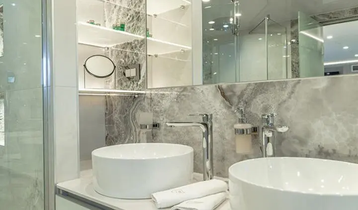 Bathroom ensuite washbasin area on Freedom yacht, modern sink and mirror