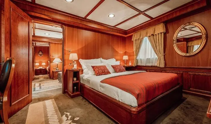 Seagull II master cabin with king bed, wooden paneling, ensuite hint