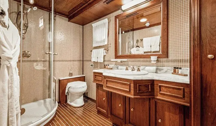Seagull II cabin ensuite bed area with wooden cabinetry and mirror