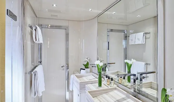 La Pellegrina 1 master cabin with king bed, ensuite, white decor and portholes