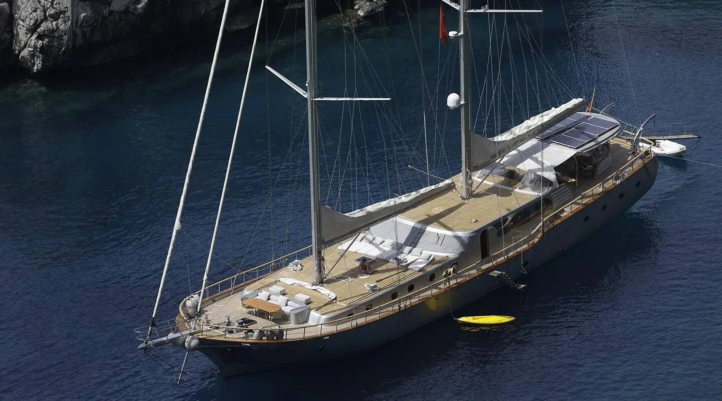 Silver Moon yacht anchored in calm blue sea with sails lowered at dusk