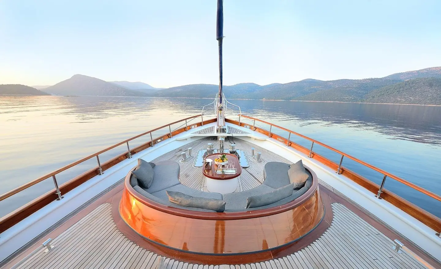 Cobra King yacht deck bow view with railing, seating, and wake-free water