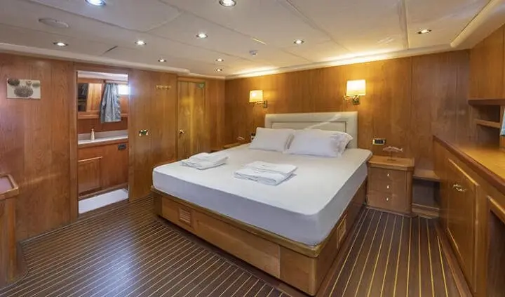Queen Of Sea cabin with king bed and wooden paneled walls