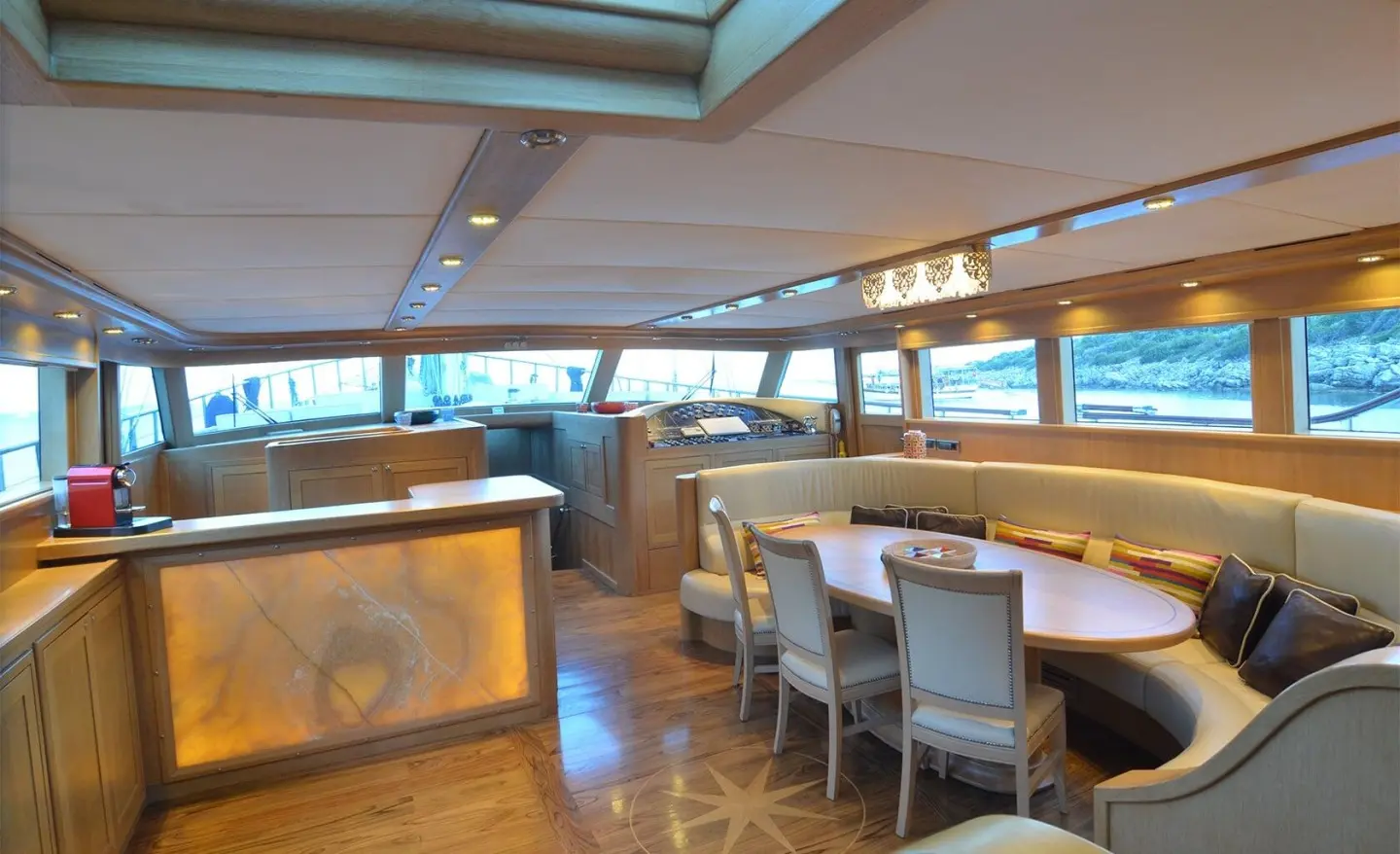Blue Heaven yacht interior with long dining table and windows at sunset